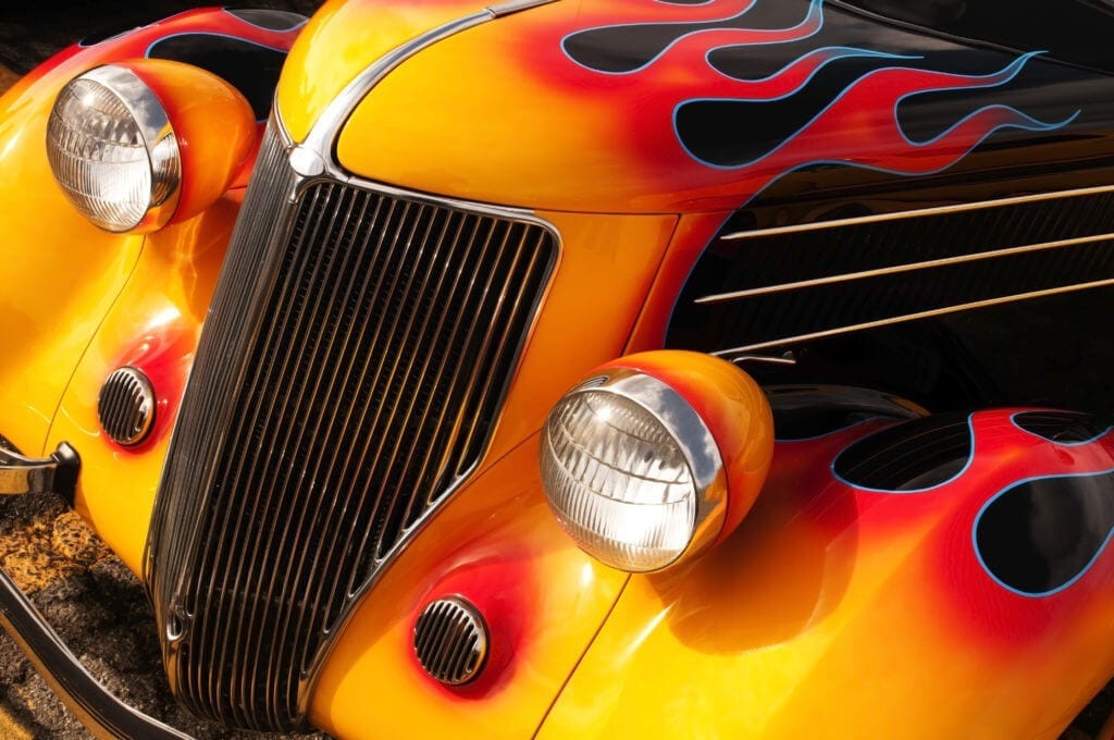 Classic hot rod with red flames on black paint.